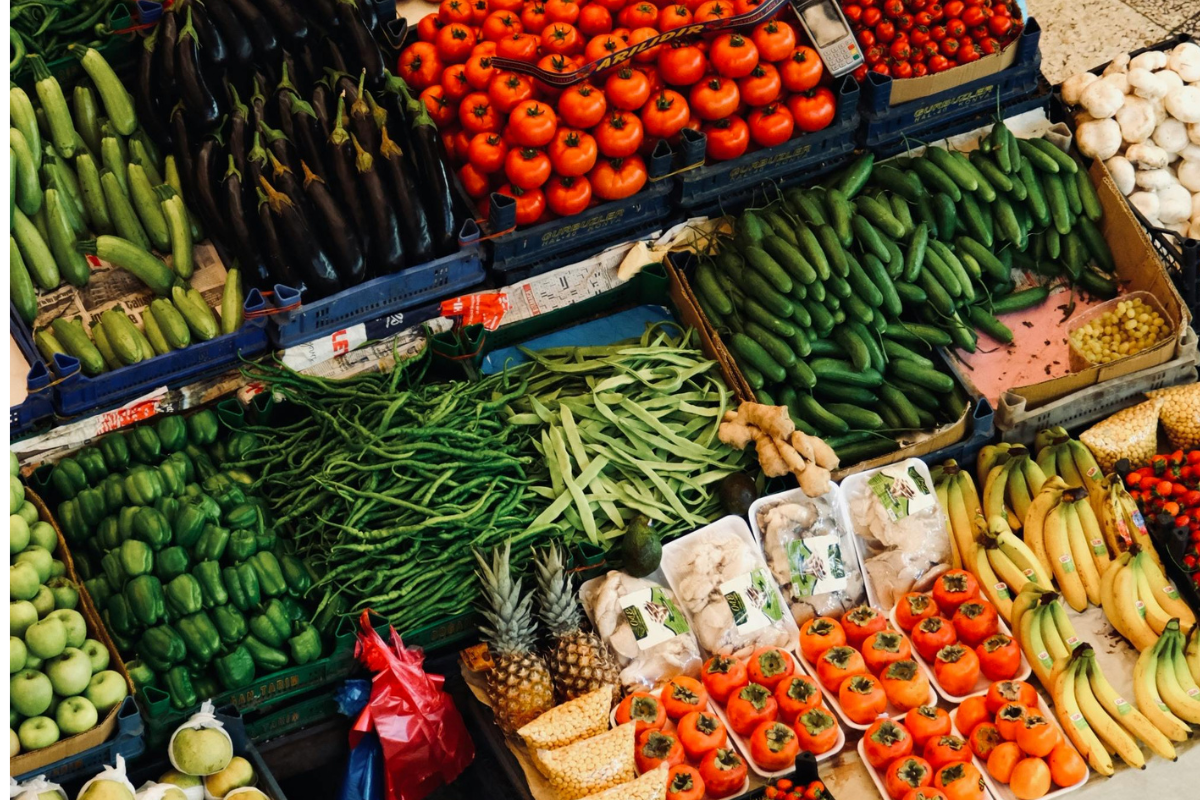 Fresh produce display at a grocery store with vegetables and fruit for meal prep planning